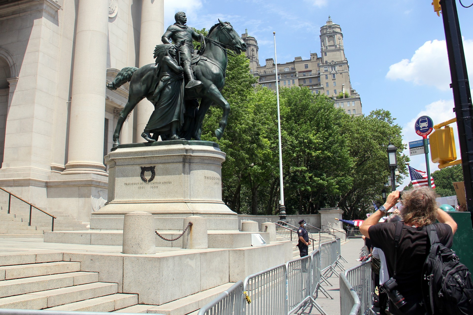 Theodore Roosevelt equestrian monument at the Museum of Natural History, protesters and spectators at the foot of the statue, New York